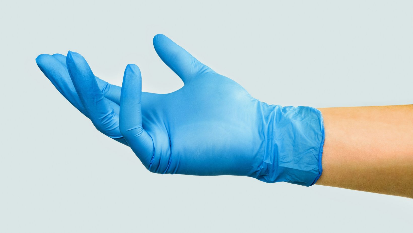 Hand in a blue rubber glove
